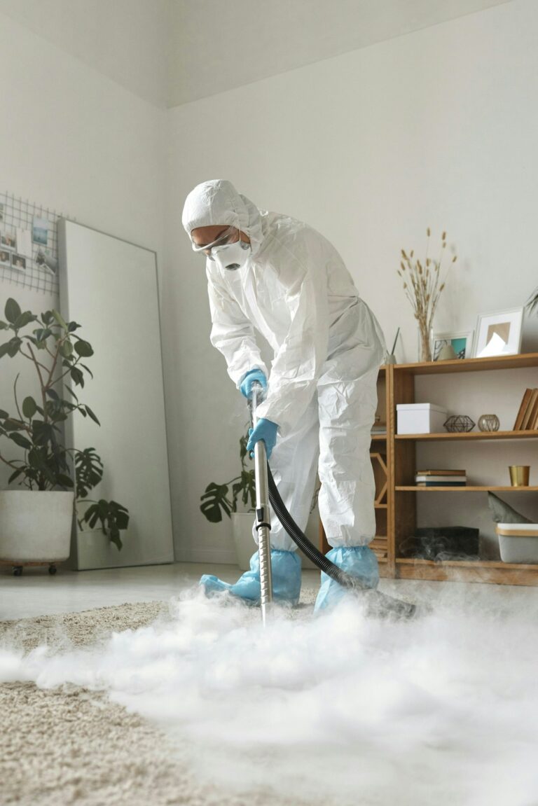 Professional carpet cleaning technician in protective suit