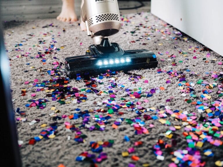 Person vacuuming a carpet at home - carpet cleaning cost in Dallas-Fort Worth